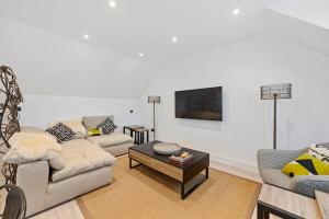 a living room with two couches and a coffee table at Grange Cottage in Galashiels