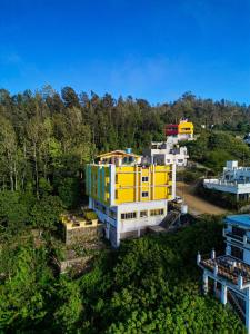 an aerial view of a yellow and white building at Iyal Hotels and Resorts in Salem
