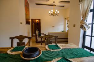 a dining room with a table with a bowl and chairs at pumzika hill in Arusha