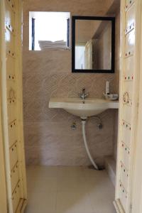 a bathroom with a sink and a mirror on the wall at Desert Nights in Mandāwa