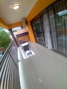a balcony with a table and chairs on a house at Bosago lodge and Spa in Burgersfort