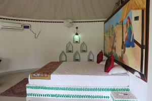 a bedroom with a bed in a room at Desert Nights in Mandāwa