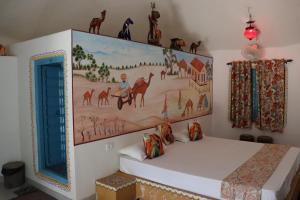 a bedroom with a large painting on the wall at Desert Nights in Mandāwa +9 photos