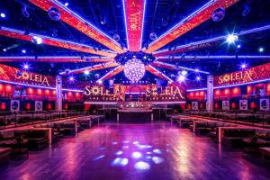 a room with a stage with red and blue lights at The Vanderpump Las Vegas Hotel & Casino - A Caesars Rewards Destination in Las Vegas