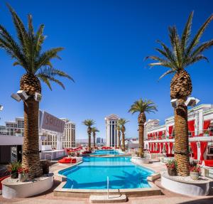 a resort with palm trees and a pool at The Vanderpump Las Vegas Hotel & Casino - A Caesars Rewards Destination in Las Vegas