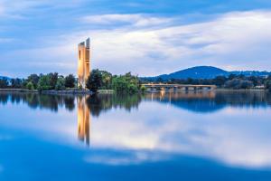 a rendering of a building on a lake at Glebe Park Cityside with Style in Canberra +2 photos