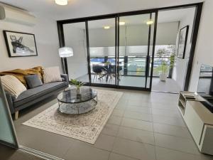 a living room with a couch and a table at Modern 1BR Views in Belconnen in Belconnen