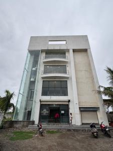 a building with two motorcycles parked in front of it at The Golden palace in Paratwāda +11 photos