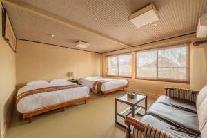 a room with two beds and a couch at Spacious Kyoto Machiya - Goemon Bath - 4BR in Kyoto +39 photos