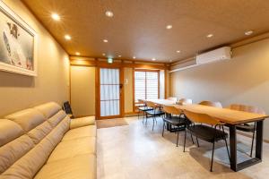 a conference room with a couch and a table and chairs at Spacious Kyoto Machiya - Goemon Bath - 4BR in Kyoto