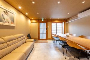 a conference room with a long table and a couch at Spacious Kyoto Machiya - Goemon Bath - 4BR in Kyoto