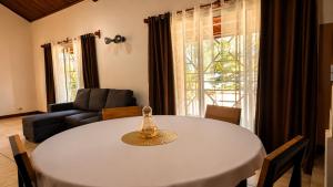 a living room with a white table and a couch at Villa de charme in Ivato