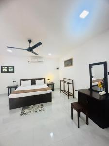 a bedroom with a bed and a mirror and a dresser at Arcadiaa Hotel in Anaulundawa