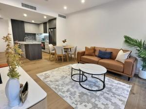 a living room with a couch and a table at Contemporary 2BR Stay in Campbell