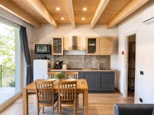 a kitchen and dining room with a wooden table and chairs at Residence Belvedere by Lago Reisen in Omegna