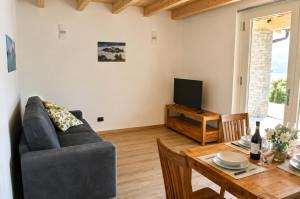a living room with a couch and a table at Residence Belvedere by Lago Reisen in Omegna