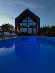 a swimming pool in front of a building at Lux House in Hadžići +40 photos