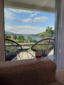 a cup of coffee sitting on a chair on a balcony at Vila Ella Mavrovo in Mavrovo