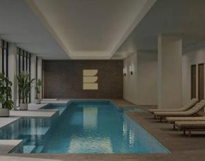 a swimming pool in a building with lounge chairs and sidx sidx sidx at Stylish 1BR Getaway and Option for 2nd Br in Campbell