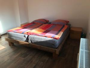 a bed with a colorful blanket on it in a room at Wohnung Regina in Wildenfels