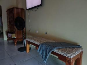 a living room with a bench and a flat screen tv at Round Hill View Heights in Pedro Cross