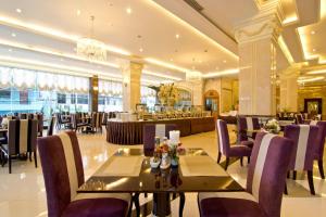 a restaurant with tables and chairs and a bar at CT Suite in Pattaya South