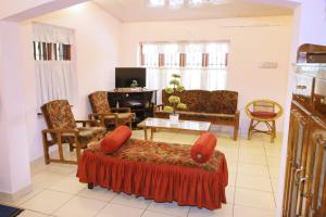 a living room with a couch and a table at Alleppey La Casa in Alleppey