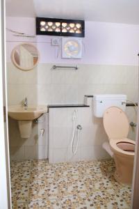 a bathroom with a toilet and a sink at Alleppey La Casa in Alleppey +15 photos