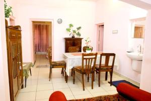 a dining room with a table and chairs and a sink at Alleppey La Casa in Alleppey