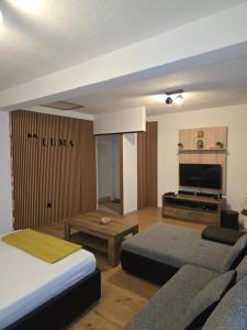 a living room with a bed and a couch at Holiday house LUMA in Hrvace