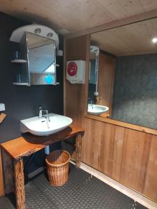 a bathroom with two sinks and a mirror at Panorama Hotel Wagenkehr in Innertkirchen