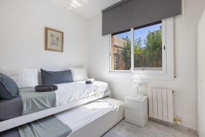 a small bedroom with a bed and a window at Villa Sueños Piscina Costa Dorada in Calafell