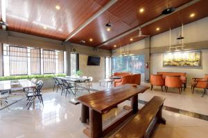 a large room with tables and chairs and a table at Urbanview Hotel Delima 101 Syariah in Serang
