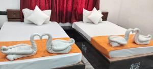 two beds with swans made out of towels at Hotel Royal Orbit in Rajauli +8 photos