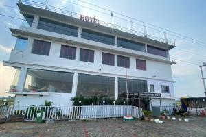 a white building with a fence in front of it at Hotel Royal Orbit in Rajauli