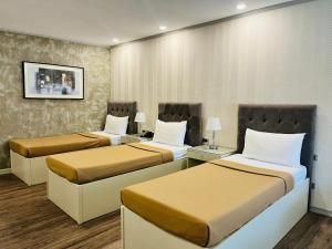 a hotel room with two beds in it at La Maja Rica Hotel in Tarlac +22 photos