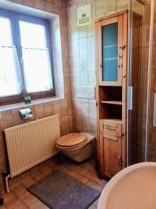 a bathroom with a toilet and a sink at Ferienwohnung Schösserhof in Reith bei Kitzbühel +34 photos