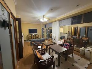 a living room with a table and chairs and a couch at 美々パレスー沖縄の伝統文化に出会う琉球モダンな隠れ家ー in Itoman