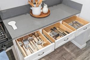a kitchen counter with drawers filled with utensils at Casa Playa Long Beach in Long Beach +34 photos