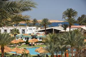 a view of a resort with a pool and palm trees at Ghazala Beach in Sharm El Sheikh