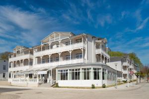 a large white building on the corner of a street at Hotel Selliner Hof in Ostseebad Sellin