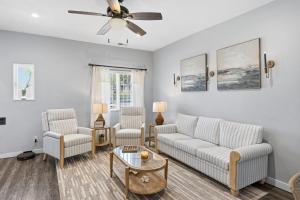 a living room with two couches and a ceiling fan at Casa Playa Long Beach in Long Beach
