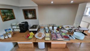 a wooden table with food on it in a kitchen at Apartmány Miluška in Bešeňová