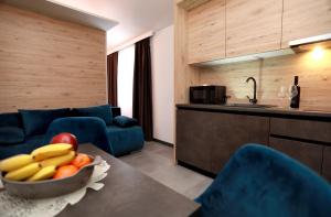 a kitchen with a bowl of fruit on a table at Kapov's Rooms in Kaštela