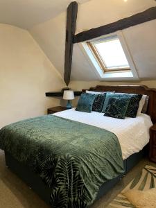 a bedroom with a bed and a window at 2 Bed Period Flat with parking in Ross on Wye