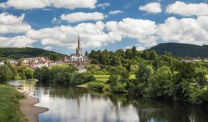 a view of a river with a town in the background at 2 Bed Period Flat with parking in Ross on Wye