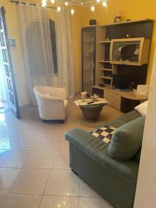 a living room with a couch and a tv at Sweet home Torre del lago in Torre del Lago Puccini