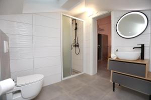 a bathroom with a toilet and a sink and a mirror at Kapov's Rooms in Kaštela +42 photos