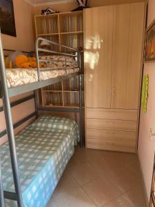 a small bedroom with a bunk bed and a closet at Sweet home Torre del lago in Torre del Lago Puccini