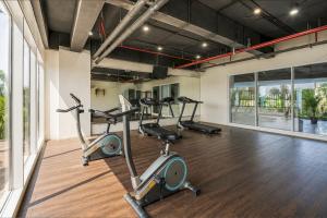 a gym with three exercise bikes in a room at Sunday Hotel Antero Jababeka in Cikarang